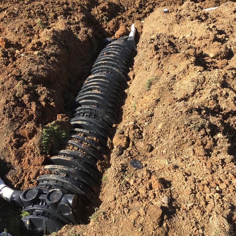 Septic system field line installation in trench