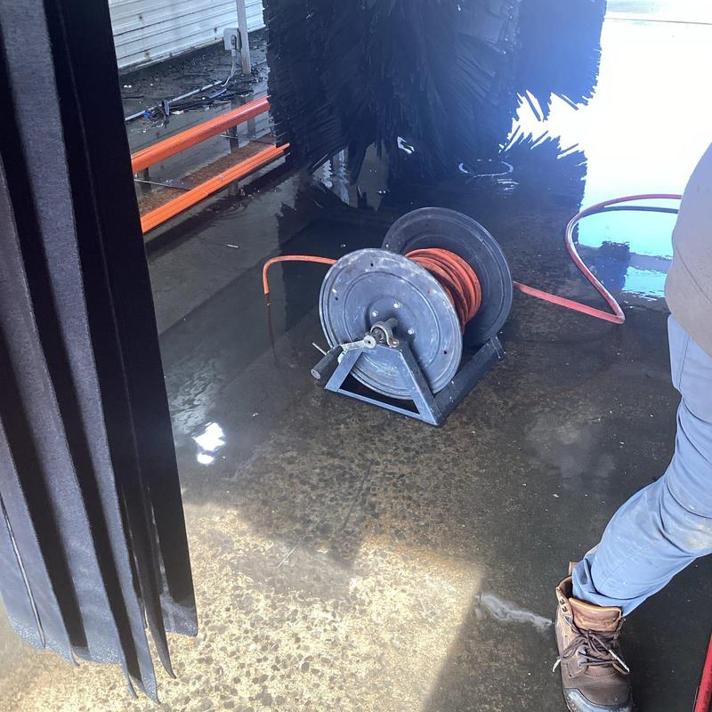 Hydro-jet drain line hose reel on wet floor