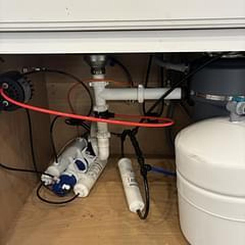 Kitchen sink drain pipes and water filtration system under cabinet