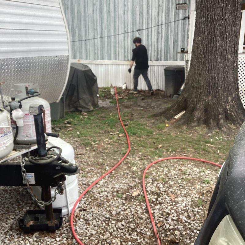 Drain line hydro-jetting with hose at mobile home
