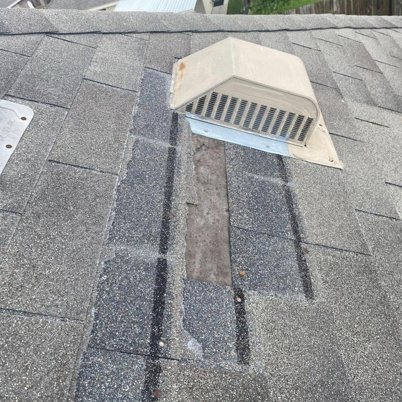 Attic vent flashing with missing shingles on roof