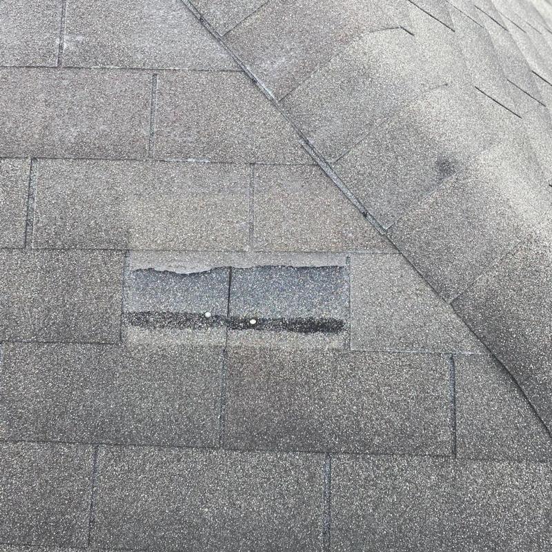 Asphalt shingles with missing granules and exposed nails
