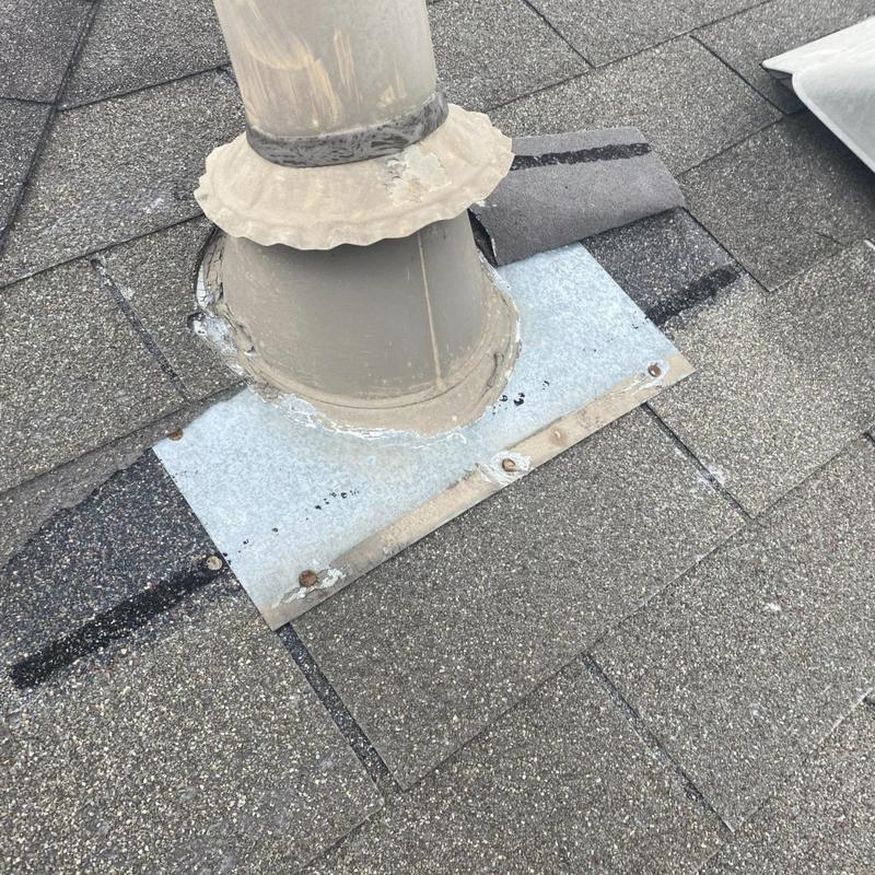 Pipe jack flashing with shingle repair on roof