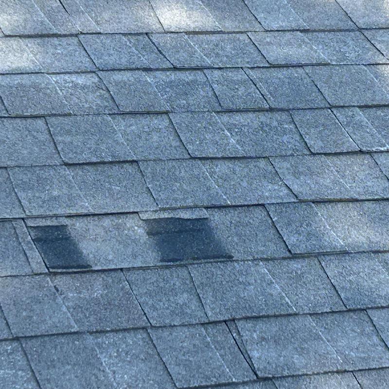 Roof shingles with visible wear and discoloration
