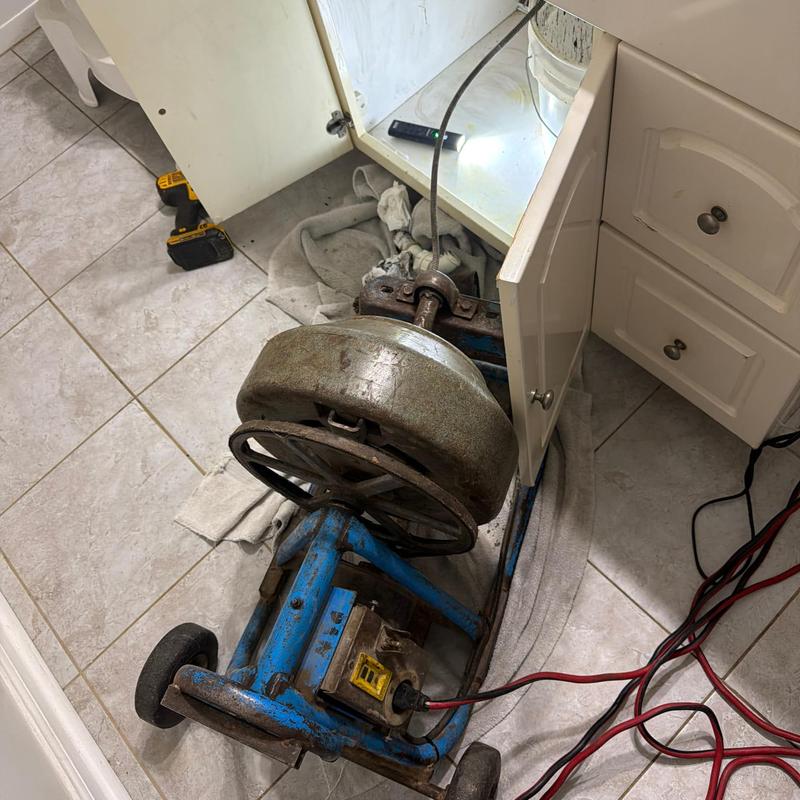 Vanity line drain auger machine inside cabinet