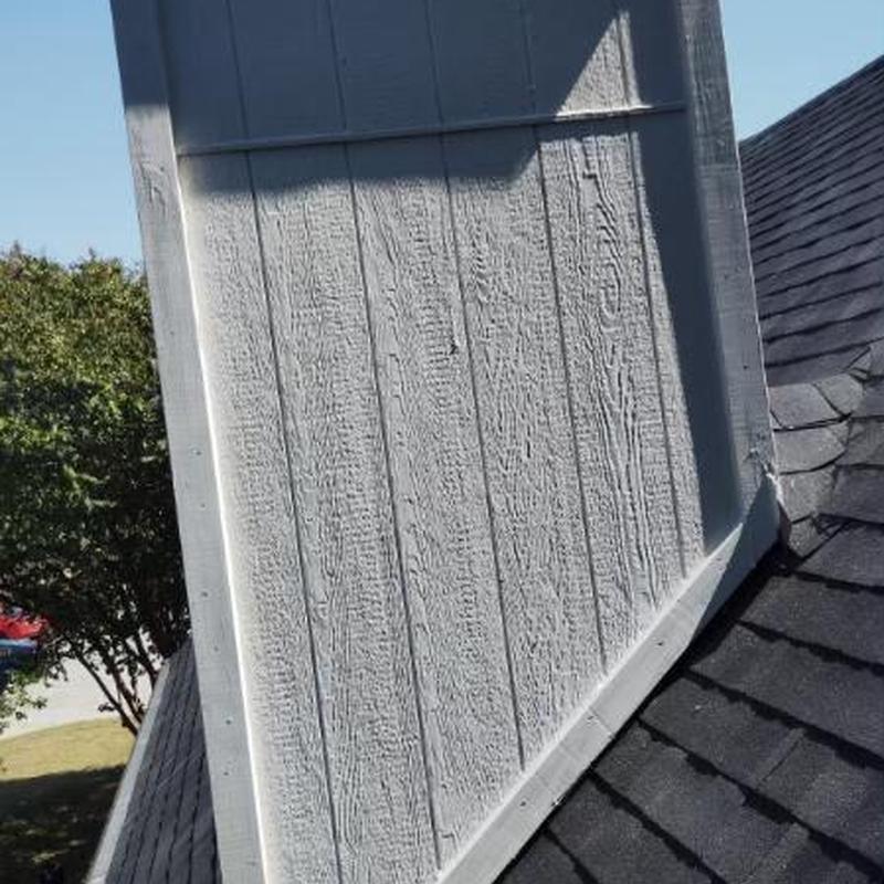 Chimney base flashing and shingle installation on roof