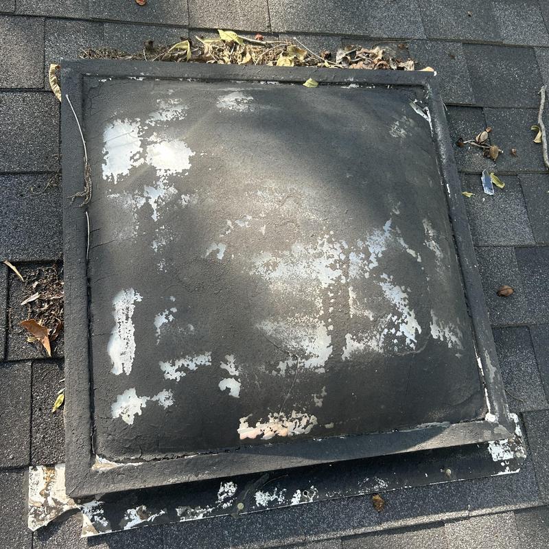 Roof vent cover with peeling paint and weather damage