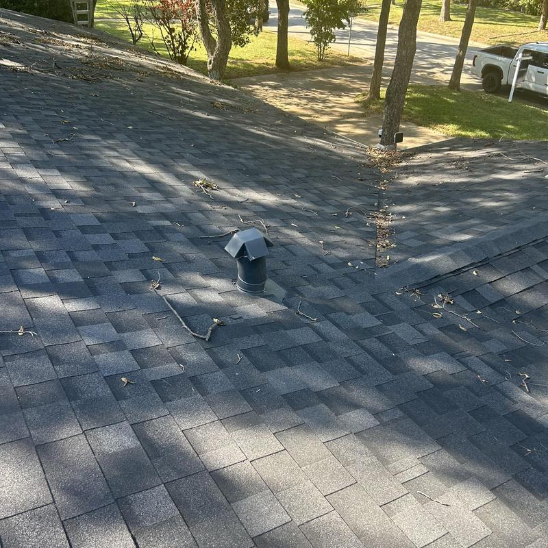 Asphalt shingle roof with vent pipe and debris