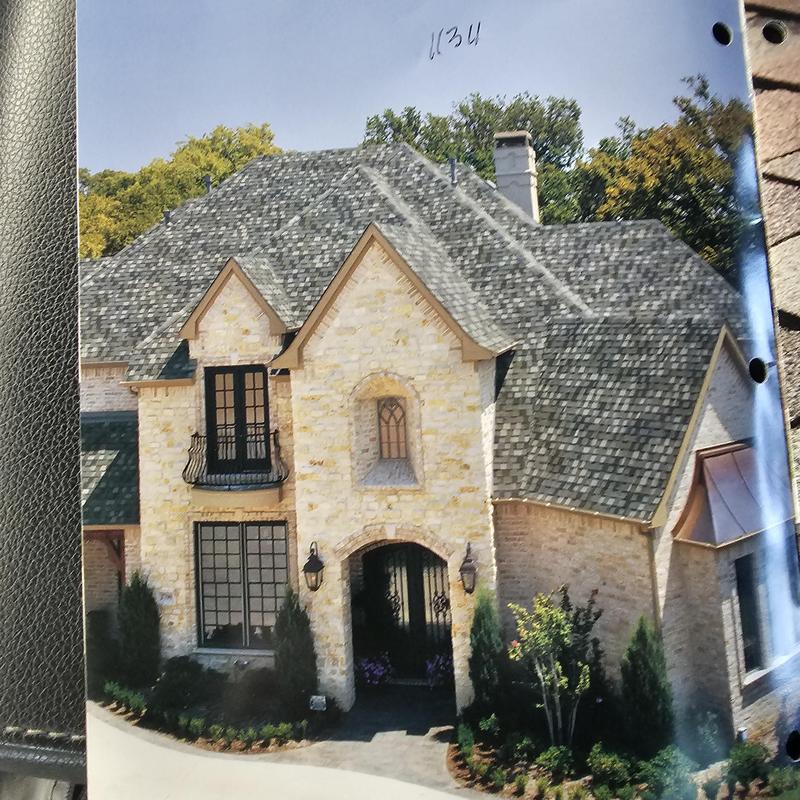 Asphalt shingle roof with hail damage on residential home