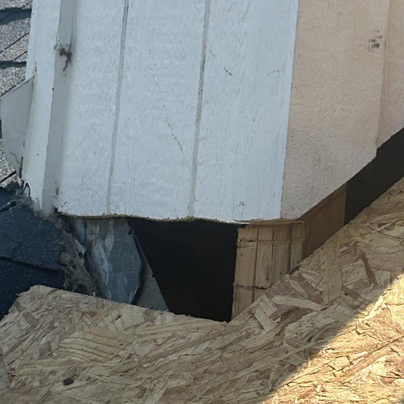 Chimney base lacking supportive decking and roofing materials