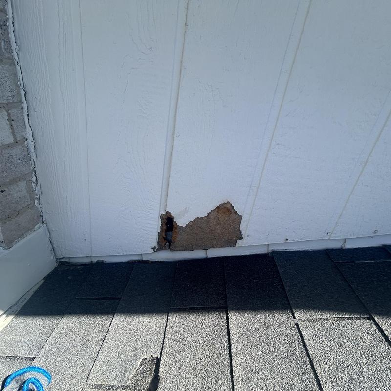 Wood siding damage near roof and porch edge
