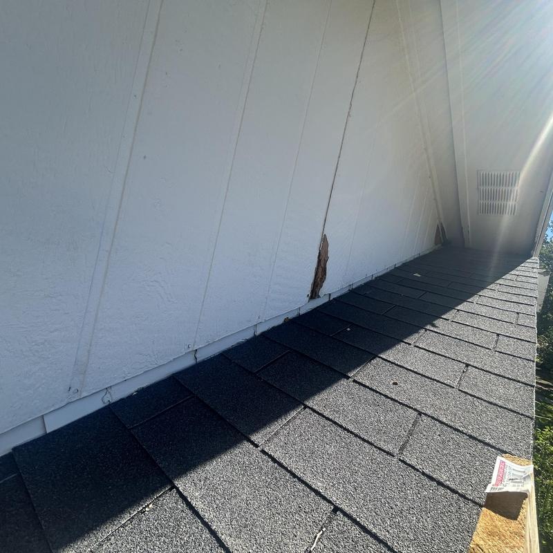 Roof siding damage with rotted wood near porch area