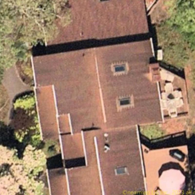 Flat roof with skylights and patio furniture visible