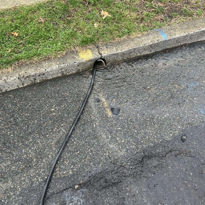 Drainpipe jetting hose clearing clogged storm drain Drainpipe jetting hose clearing clogged storm drain