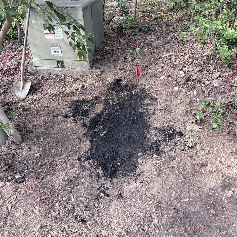 Underground PVC and conduit pipe excavation near utility box
