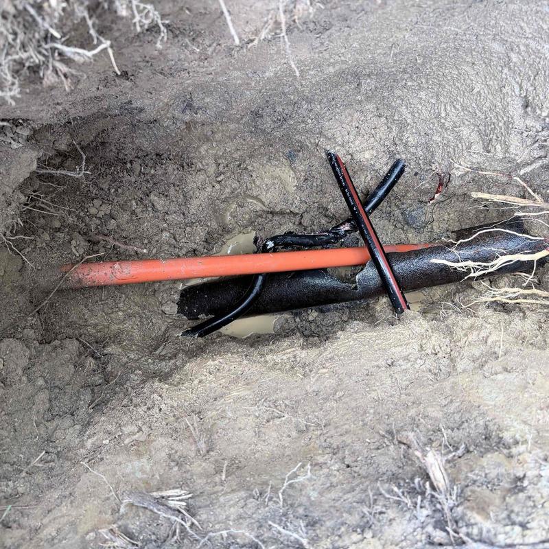 PVC and orange conduit pipes underground repair site