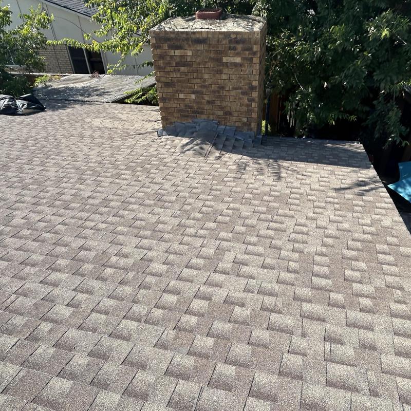 Asphalt shingle roof and chimney flashing installation