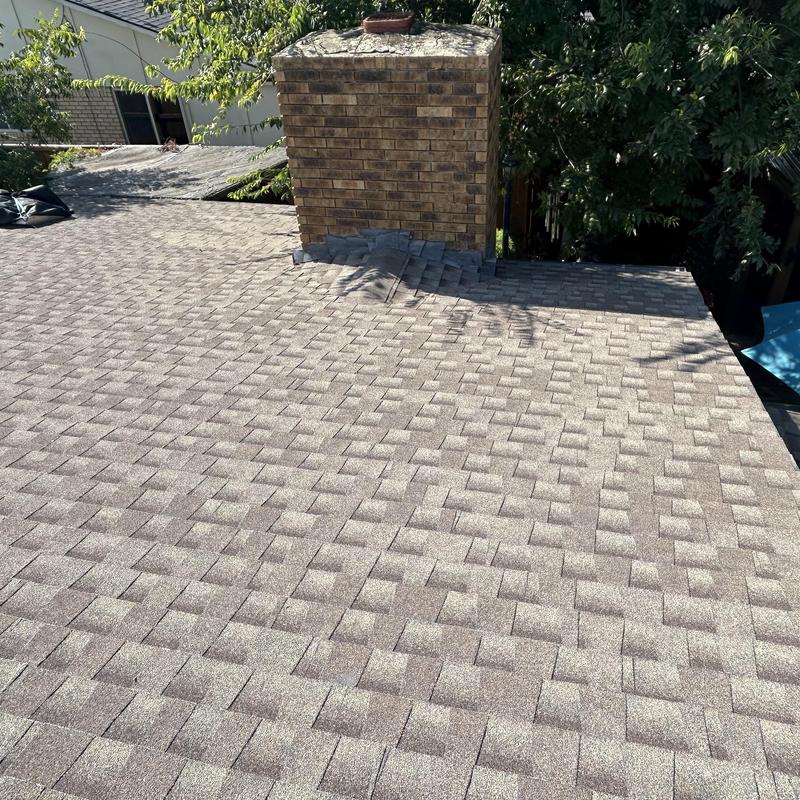 Asphalt shingle roof near brick chimney in Fort Worth
