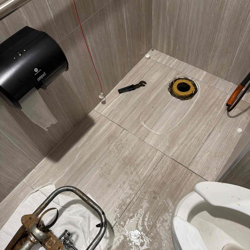 Toilet flange and drain line with plumbing tools