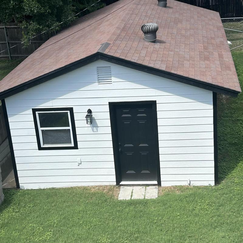 Asphalt shingle roof with turbine vents on shed