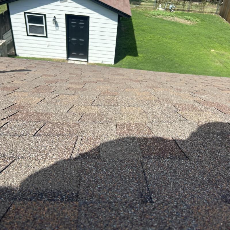 Asphalt shingle roof surface with inspection shadow