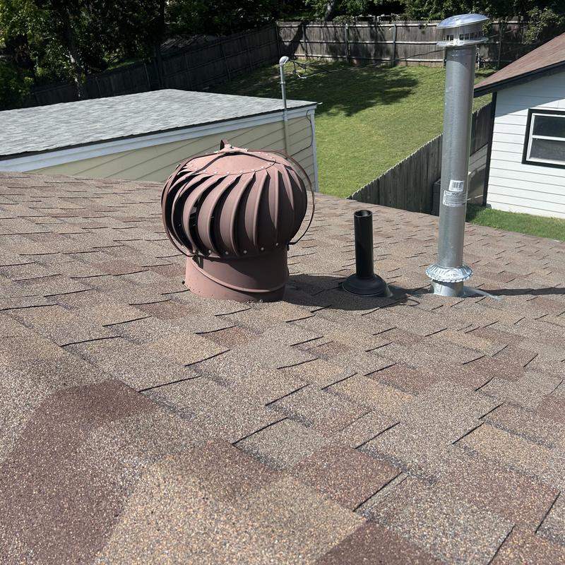 Roof exhaust vent and pipe flashing on residential roof