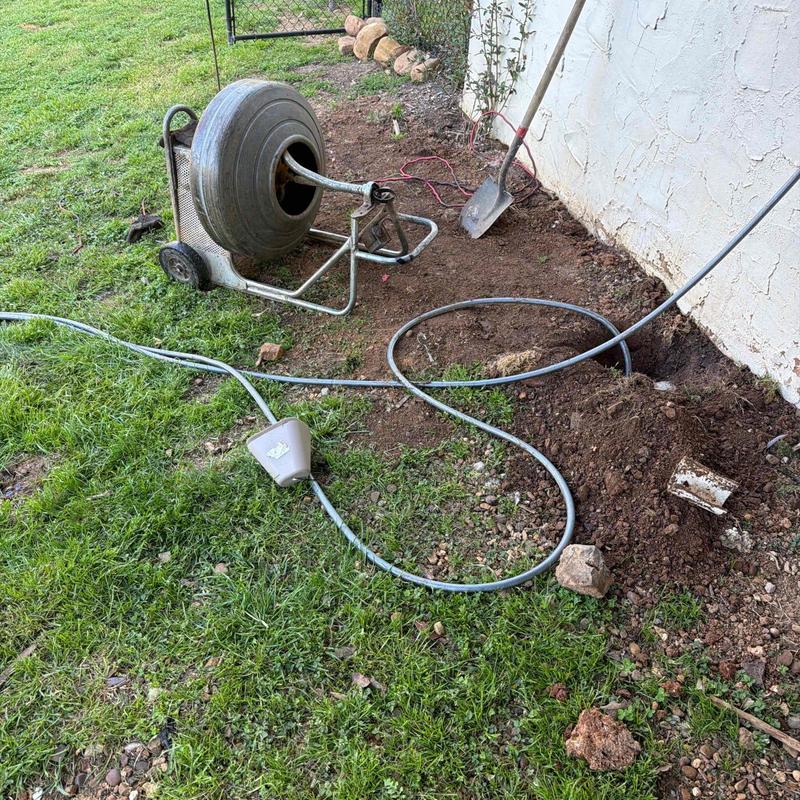 Cable mainline being snaked from access point outdoors