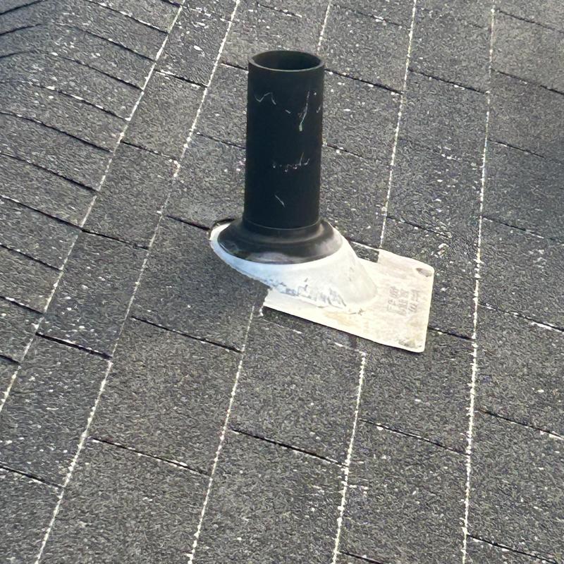 Roof pipe flashing on asphalt shingle roof