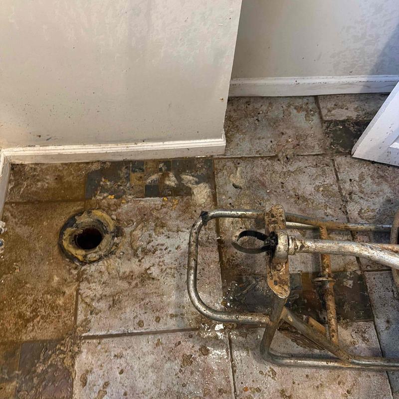 Main sewer line cleanout with plumbing snake tool