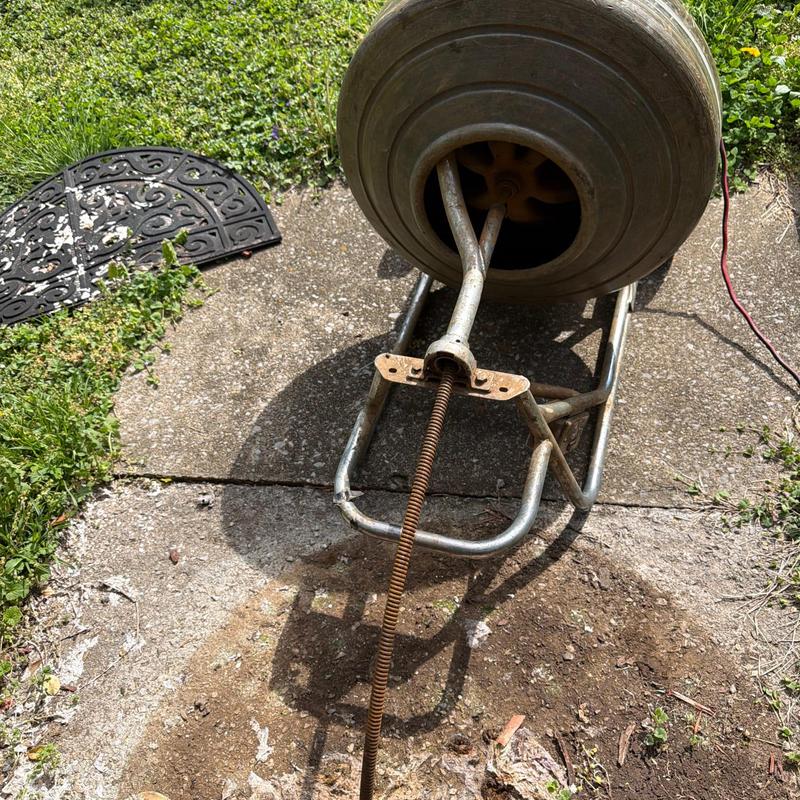 Mainline drain cable with inspection drum on concrete