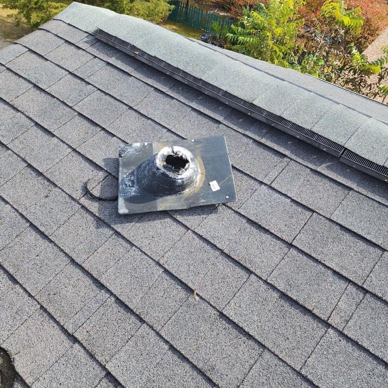 Pipe boot on shingle roof with damage visible