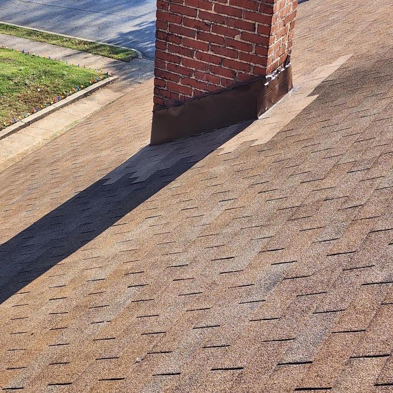 Chimney flashing installation on asphalt shingle roof