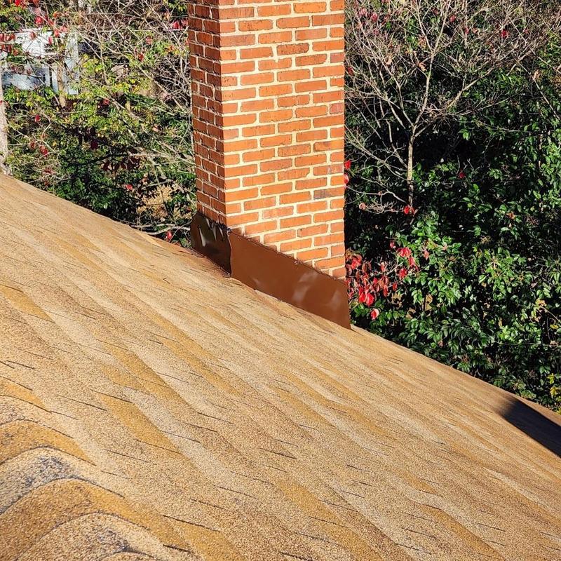 Chimney flashing installation on asphalt shingle roof