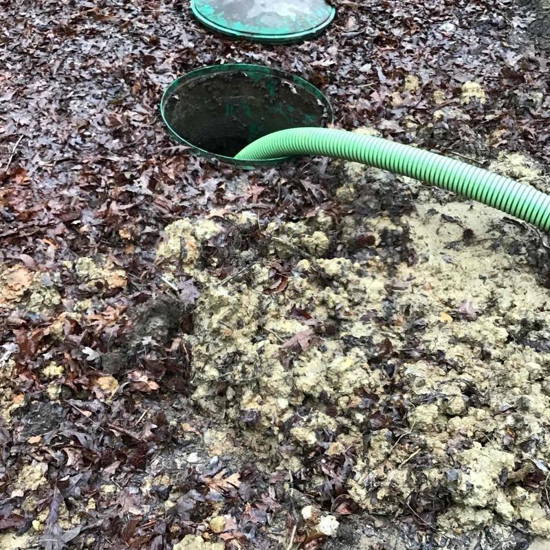 Septic tank with suction hose during pumping service