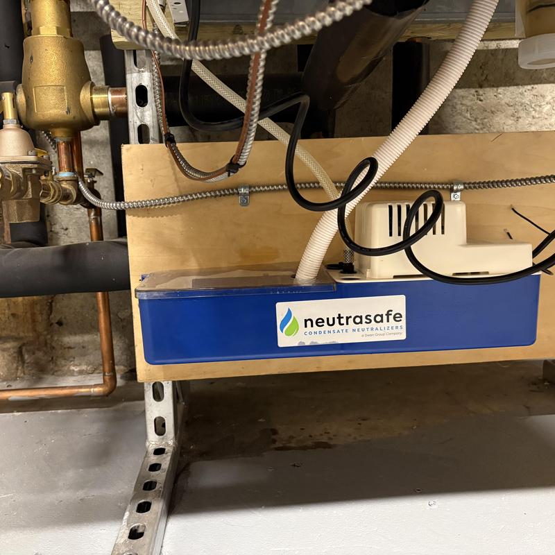 Condensate neutralizing pump installed under boiler Condensate neutralizing pump installed under boiler