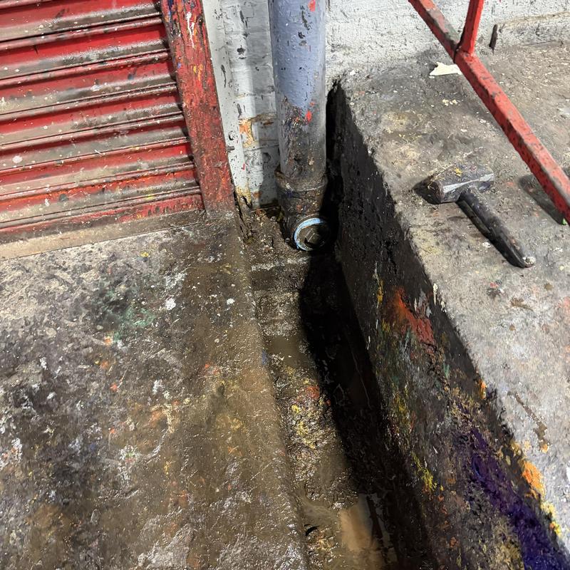 Main line pipe connection near concrete floor trench, commercial site Main line pipe connection near concrete floor trench, commercial site