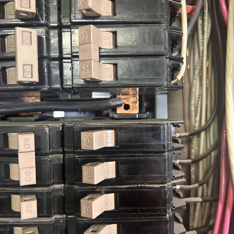 Electrical breaker panel close-up with wiring and switches Electrical breaker panel close-up with wiring and switches