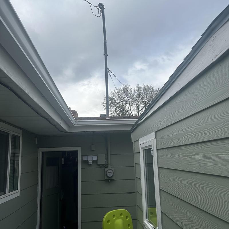 Electrical meter and service mast installation on home exterior Electrical meter and service mast installation on home exterior