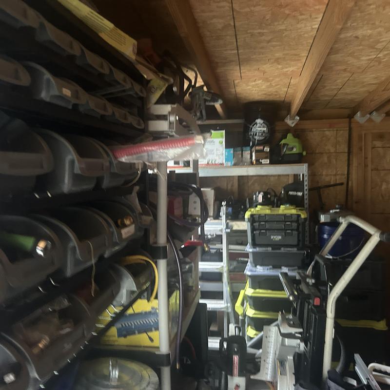 Tool storage and shelving in wooden shed interior Tool storage and shelving in wooden shed interior