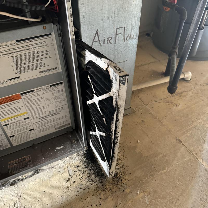 HVAC furnace filter clogged with heavy soot buildup