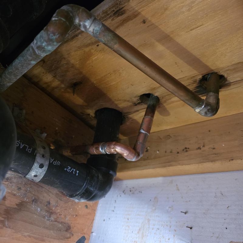Half-inch copper pipe under garage ceiling with joints