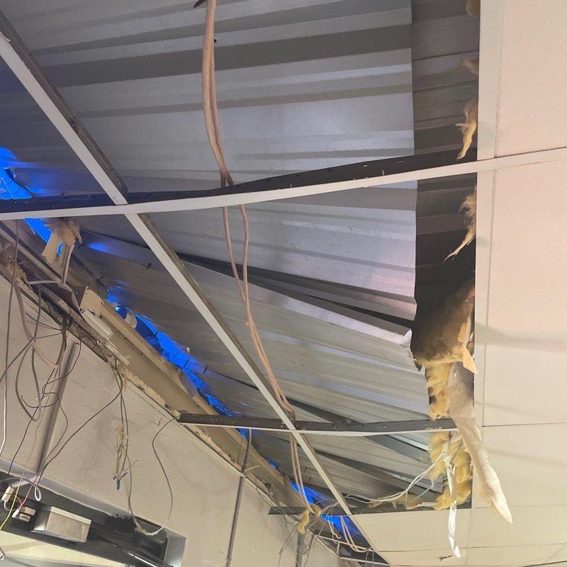 Metal panel roof damage and exposed wiring ceiling