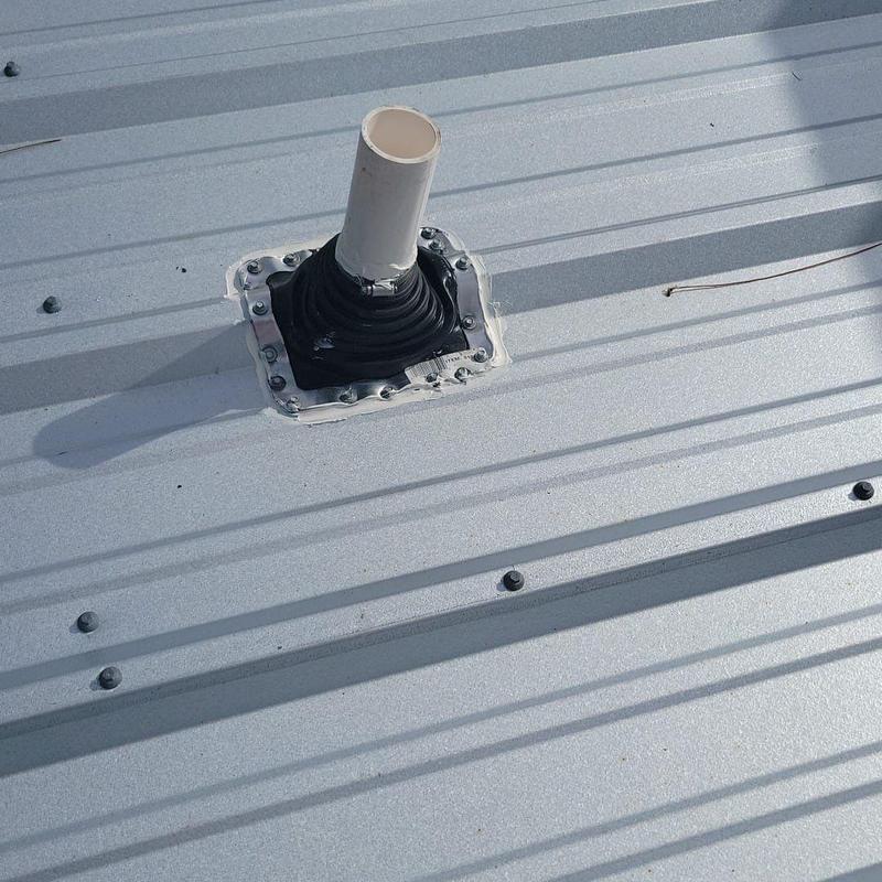 Plumbing vent pipe boot on metal roof missing sealant