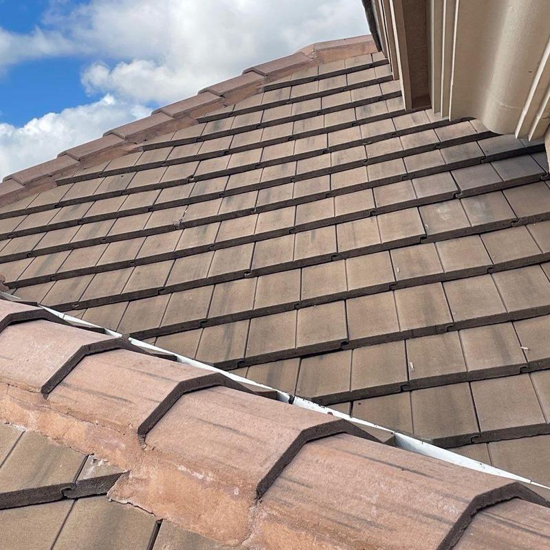 Concrete tile roof with loose and cracked tiles