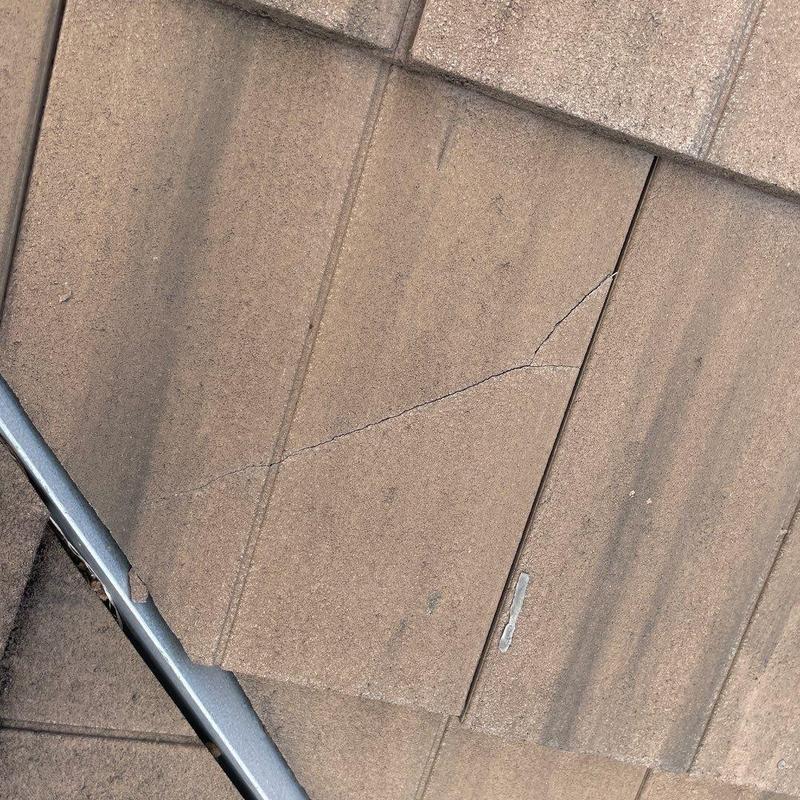 Concrete tile roof with cracked and chipped tiles