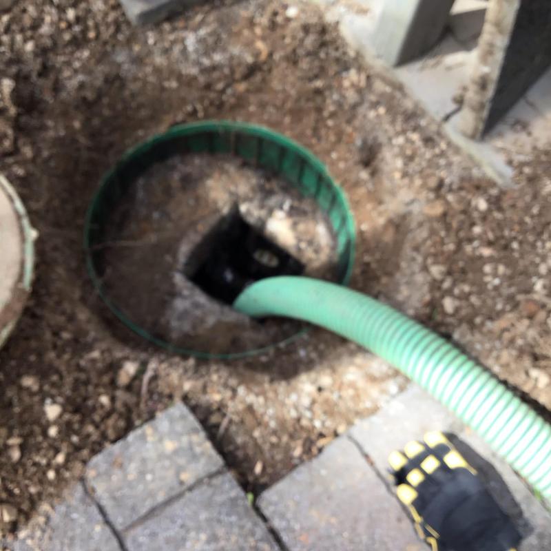 Septic tank riser with hose during pumping service