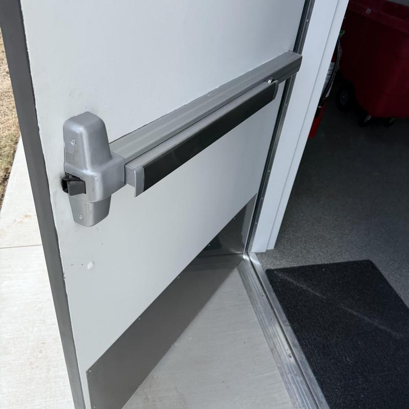 Exit device on commercial door with rekeyed lock