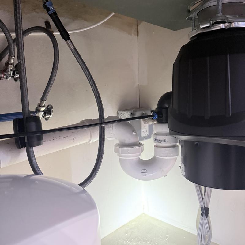 Garbage disposal and plumbing connections under sink