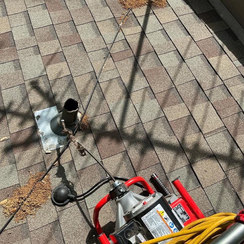 Roof vent mainline with sewer snake tool on shingles Roof vent mainline with sewer snake tool on shingles