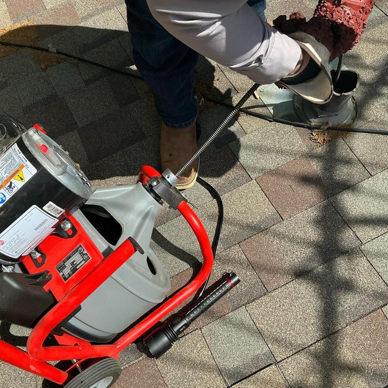 Mainline sewer auger clearing blockage from roof vent Mainline sewer auger clearing blockage from roof vent